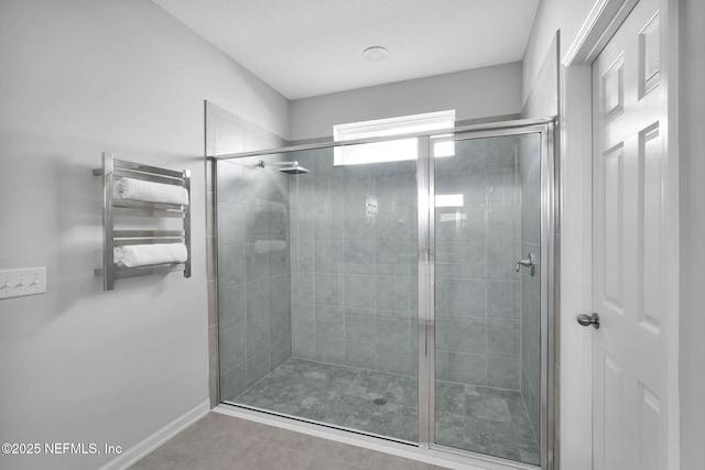 bathroom with radiator heating unit and an enclosed shower