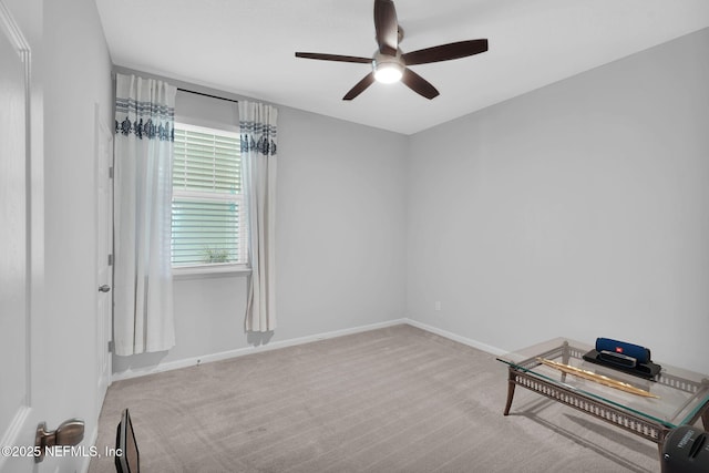 empty room with light colored carpet and ceiling fan