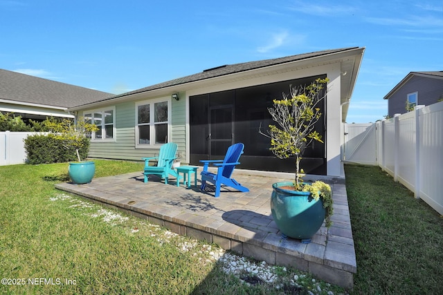 rear view of property featuring a yard and a patio