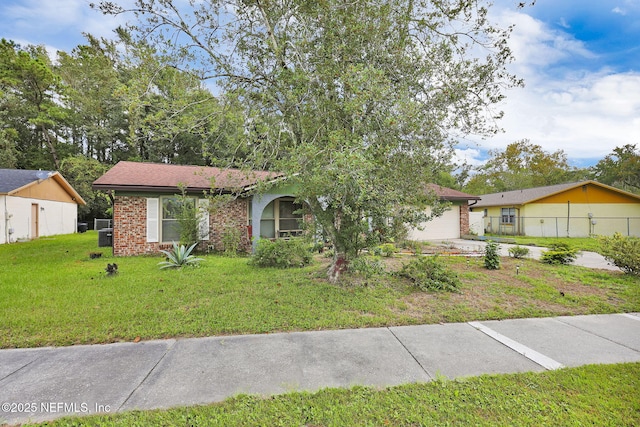 ranch-style house with a garage and a front lawn