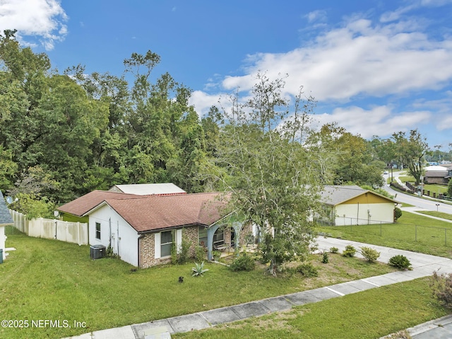 single story home with a front lawn and central air condition unit