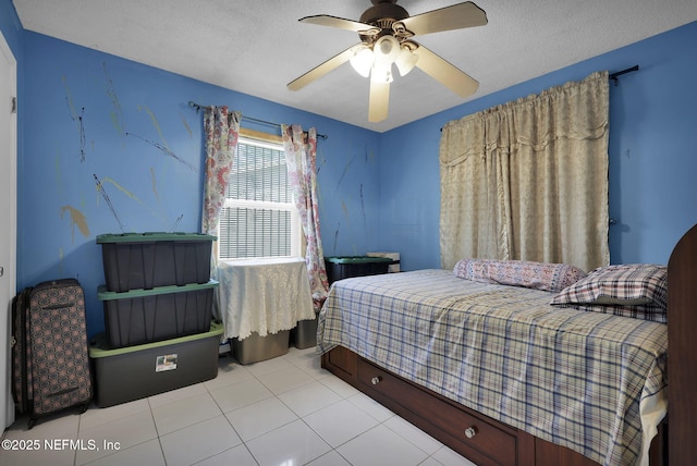 bedroom with light tile patterned floors, a textured ceiling, and ceiling fan