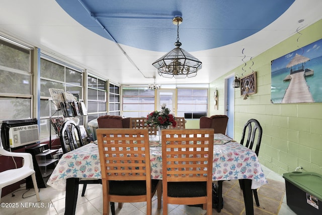 dining area with cooling unit, tile patterned flooring, and a notable chandelier