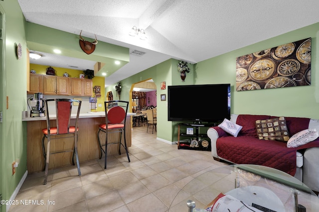 living room with lofted ceiling and a textured ceiling