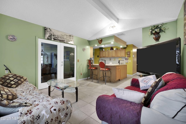 tiled living room with lofted ceiling with beams, a textured ceiling, and french doors