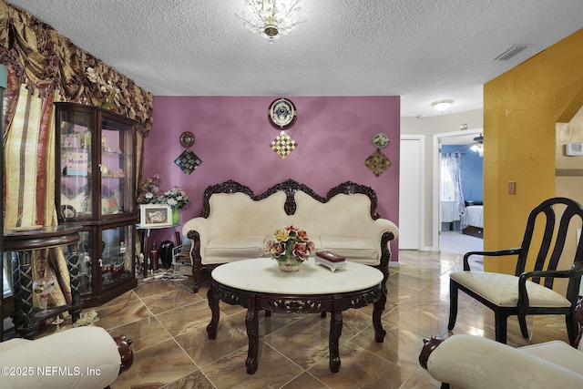 sitting room featuring a textured ceiling