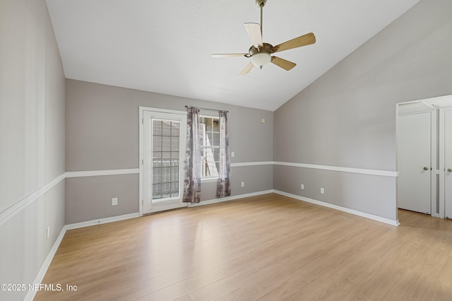 unfurnished room featuring vaulted ceiling, ceiling fan, and light wood-type flooring