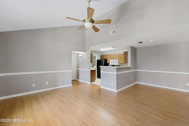 unfurnished living room featuring ceiling fan, high vaulted ceiling, and light hardwood / wood-style flooring