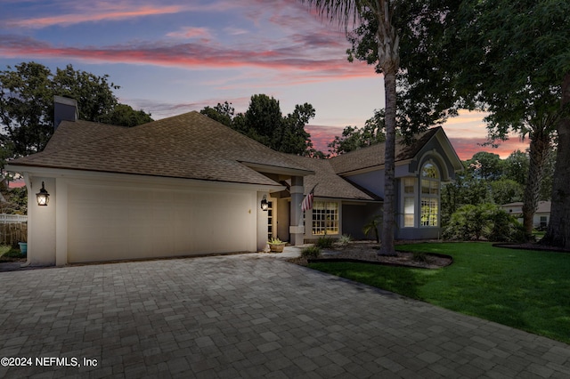 view of front facade with a garage and a yard