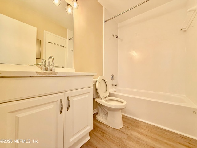 full bathroom with vanity, hardwood / wood-style floors,  shower combination, and toilet