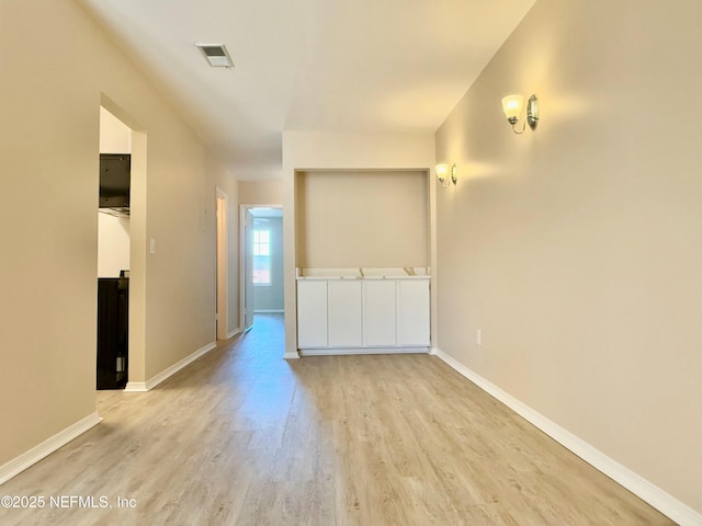 unfurnished room with light hardwood / wood-style flooring