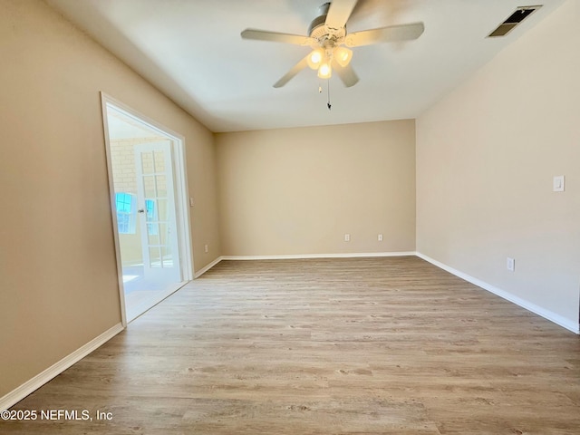 spare room with ceiling fan and light hardwood / wood-style floors