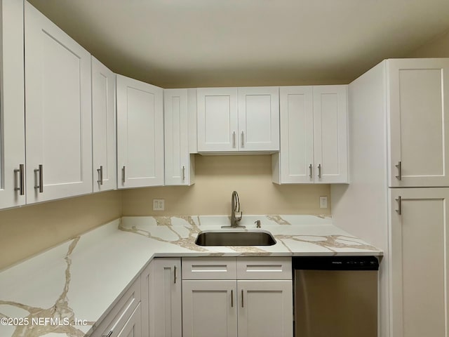 kitchen featuring white cabinetry, dishwasher, sink, and light stone counters