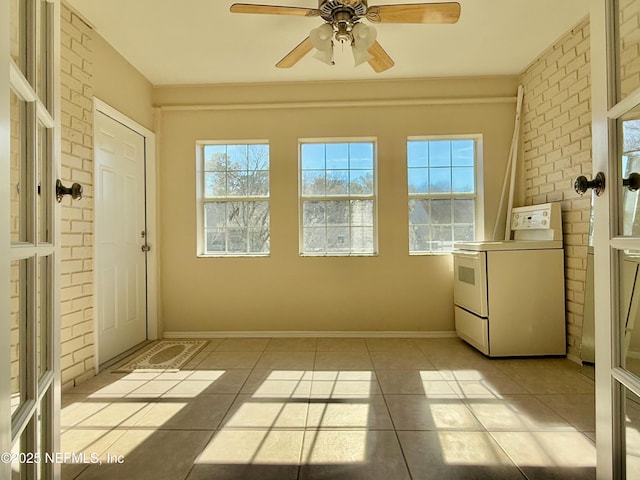 unfurnished sunroom featuring ceiling fan