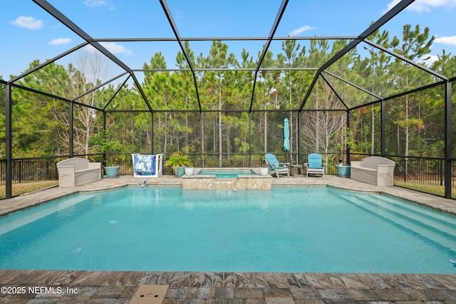 view of pool featuring a lanai, a patio, and an in ground hot tub