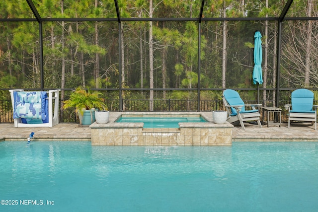 view of swimming pool featuring an in ground hot tub, glass enclosure, and a patio