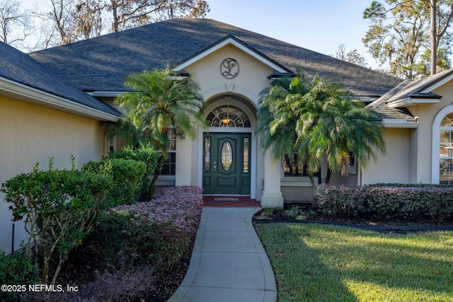 doorway to property with a yard