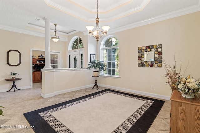 tiled entryway with crown molding, a tray ceiling, and ornate columns