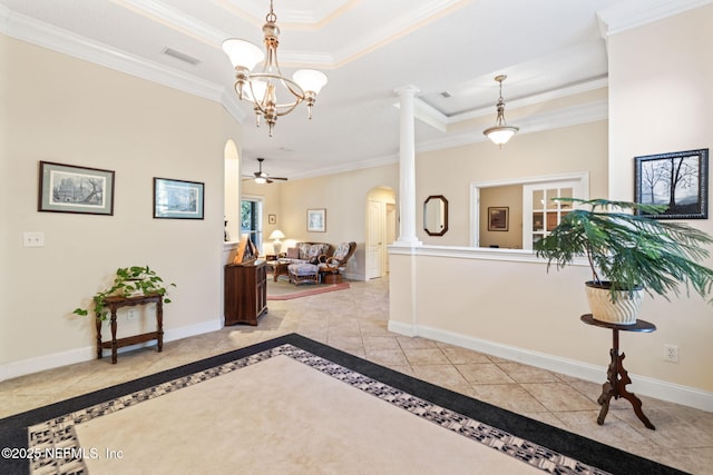 interior space featuring a raised ceiling, ornamental molding, and ceiling fan with notable chandelier