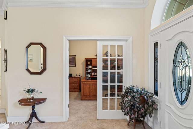 tiled entrance foyer with crown molding and french doors