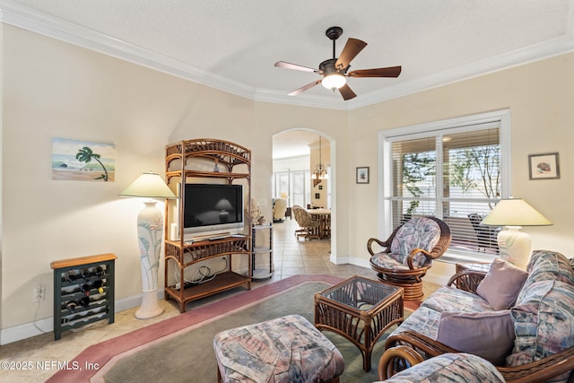 living room with light tile patterned floors, ornamental molding, and ceiling fan