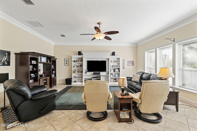 living room with ceiling fan, ornamental molding, a textured ceiling, and light tile patterned floors