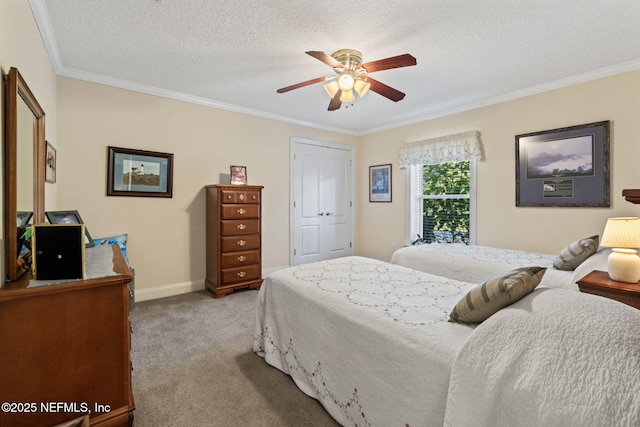 carpeted bedroom with crown molding, ceiling fan, a closet, and a textured ceiling