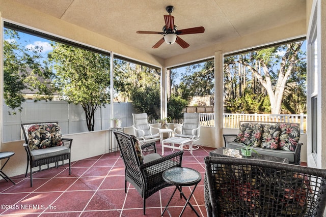 sunroom / solarium with a wealth of natural light and ceiling fan