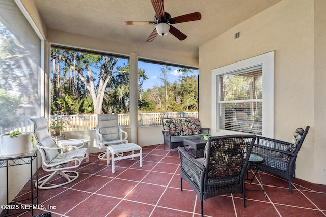 sunroom with a wealth of natural light and ceiling fan