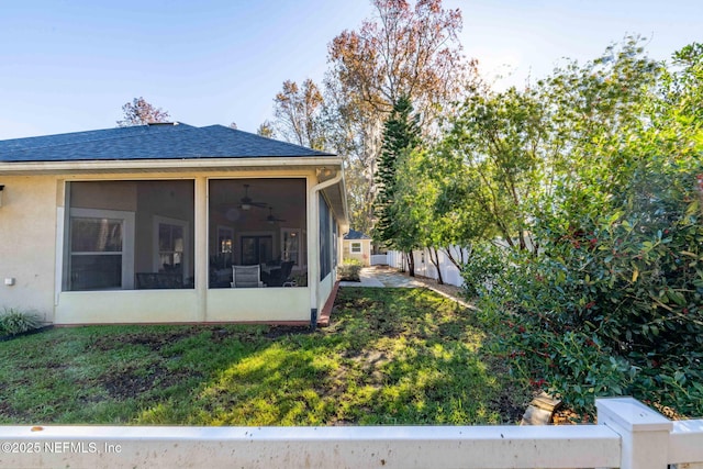 exterior space with a sunroom and ceiling fan