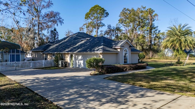 view of front of home with a garage and a front lawn