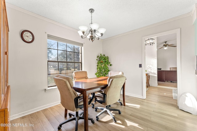 dining space featuring a notable chandelier, ornamental molding, light hardwood / wood-style floors, and a textured ceiling