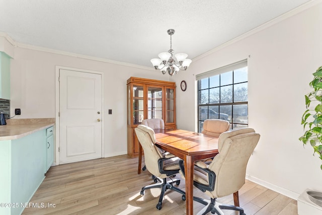 dining room featuring an inviting chandelier, crown molding, a textured ceiling, and light wood-type flooring