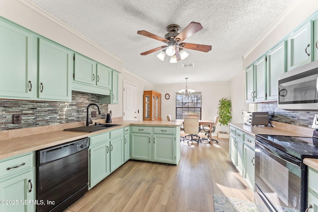 kitchen with sink, range with electric stovetop, black dishwasher, and green cabinets