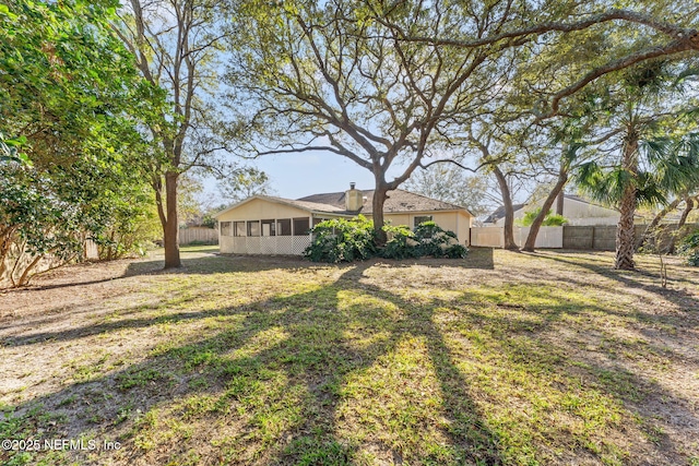 view of yard with a sunroom