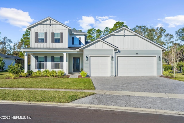 view of front of house featuring a garage and a front lawn