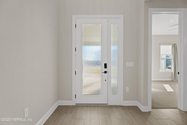 foyer entrance featuring baseboards