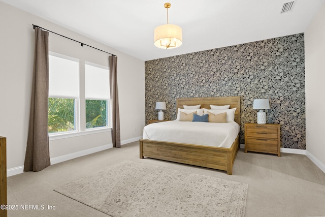 bedroom with wallpapered walls, baseboards, visible vents, an accent wall, and carpet flooring