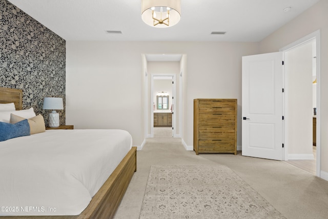 bedroom featuring light colored carpet, visible vents, and wallpapered walls