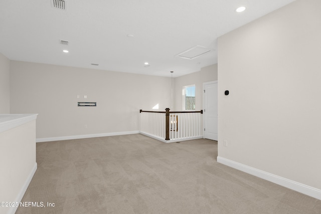 empty room featuring light carpet, recessed lighting, visible vents, and baseboards