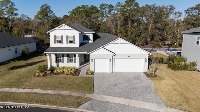 modern farmhouse style home featuring decorative driveway, roof with shingles, board and batten siding, a garage, and a front lawn