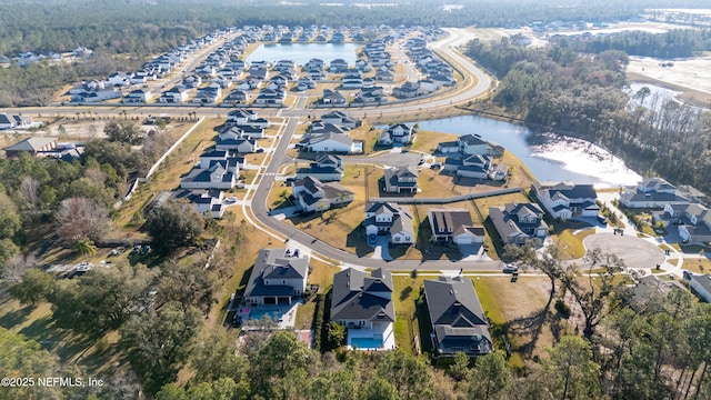 bird's eye view with a residential view and a water view