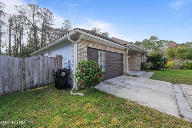 view of side of property featuring a garage and a yard