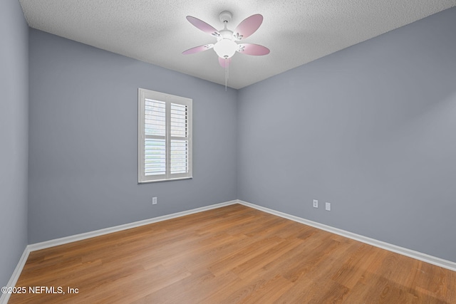 empty room with ceiling fan, a textured ceiling, and light hardwood / wood-style flooring