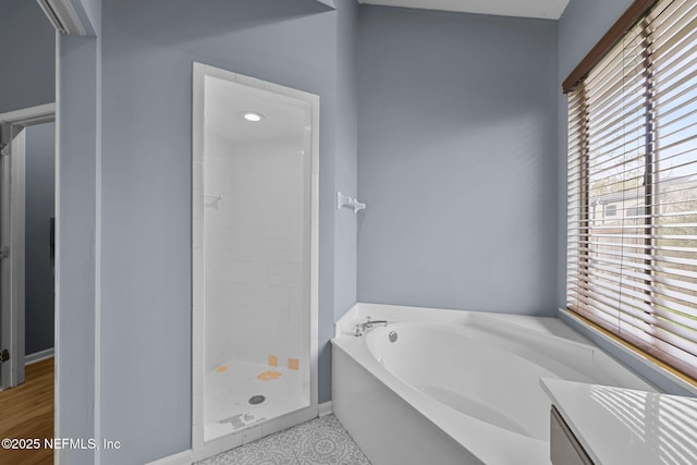 bathroom featuring separate shower and tub