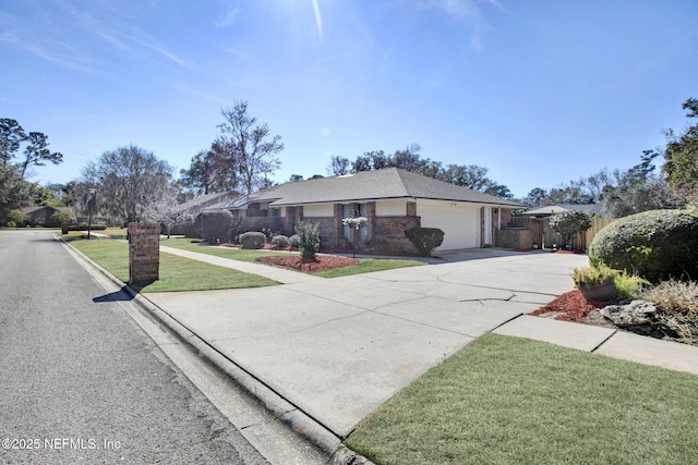 single story home with a garage and a front lawn