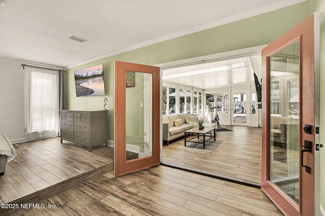 interior space with french doors, ornamental molding, and a wealth of natural light