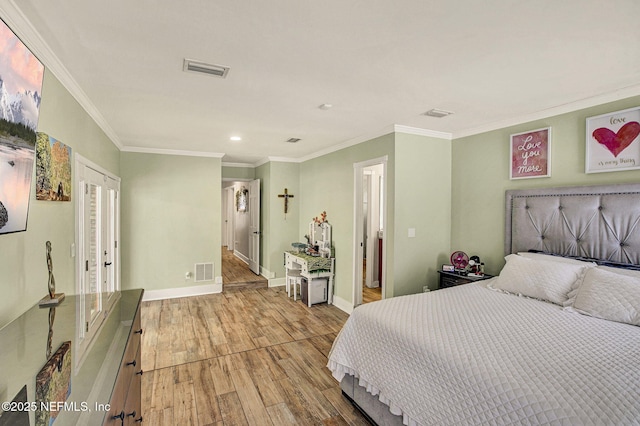 bedroom featuring crown molding and light hardwood / wood-style floors