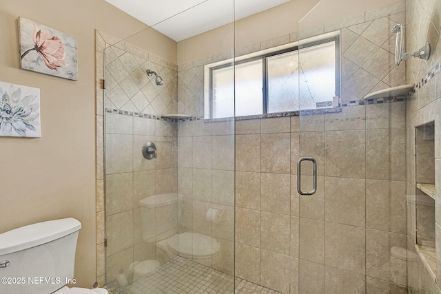 bathroom featuring an enclosed shower and toilet