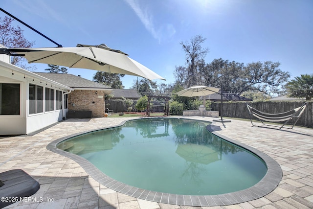 view of pool featuring a patio and a sunroom